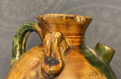 A Chinese sancai ewer and a celadon-glazed bottle vase, Tang and Song